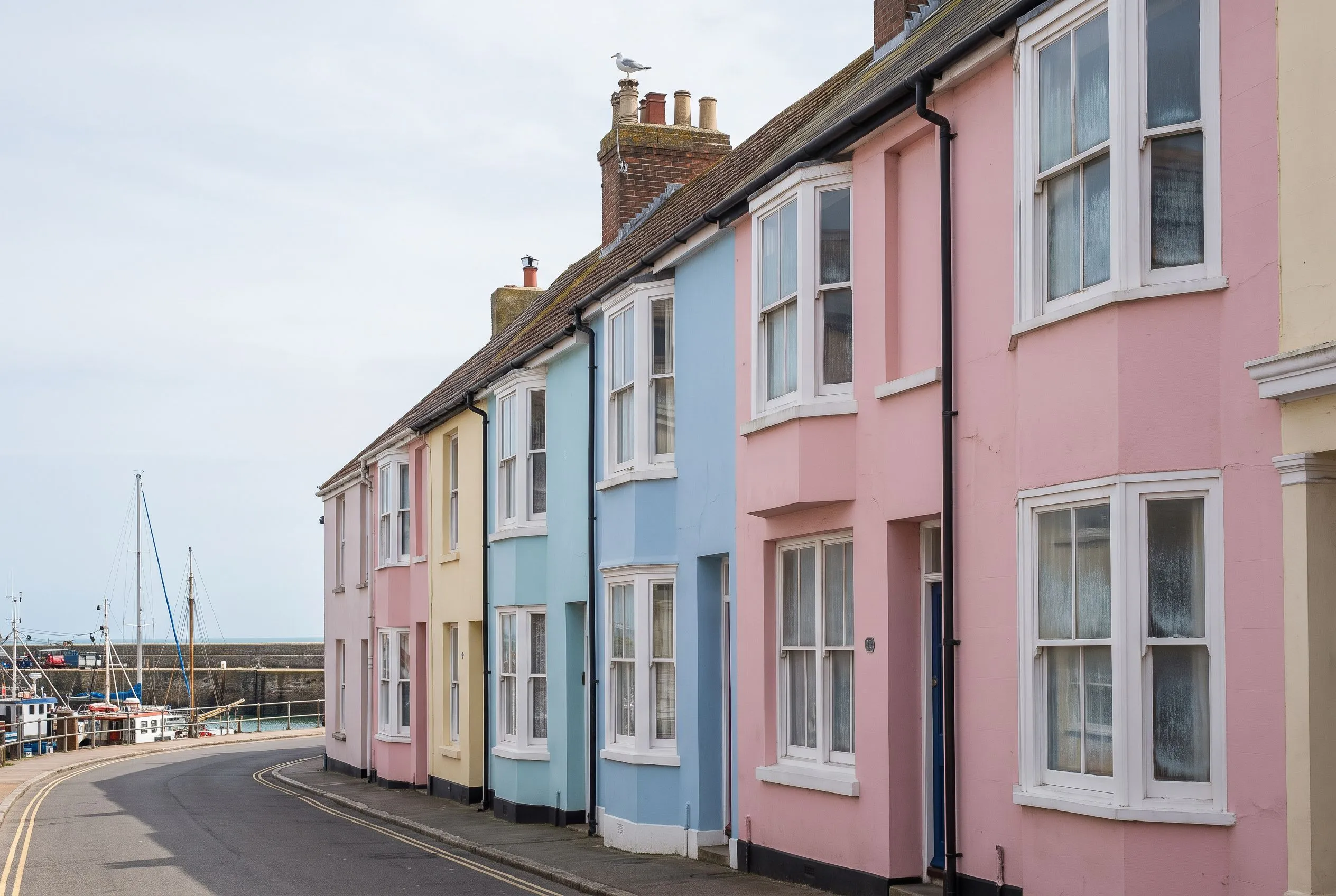 Pastel seaside terraces with a light salt haze on the windows